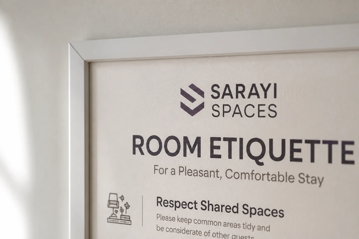 Detail of the framed Sarayi Spaces Room Etiquette board for guest guidance, with its brand and heading