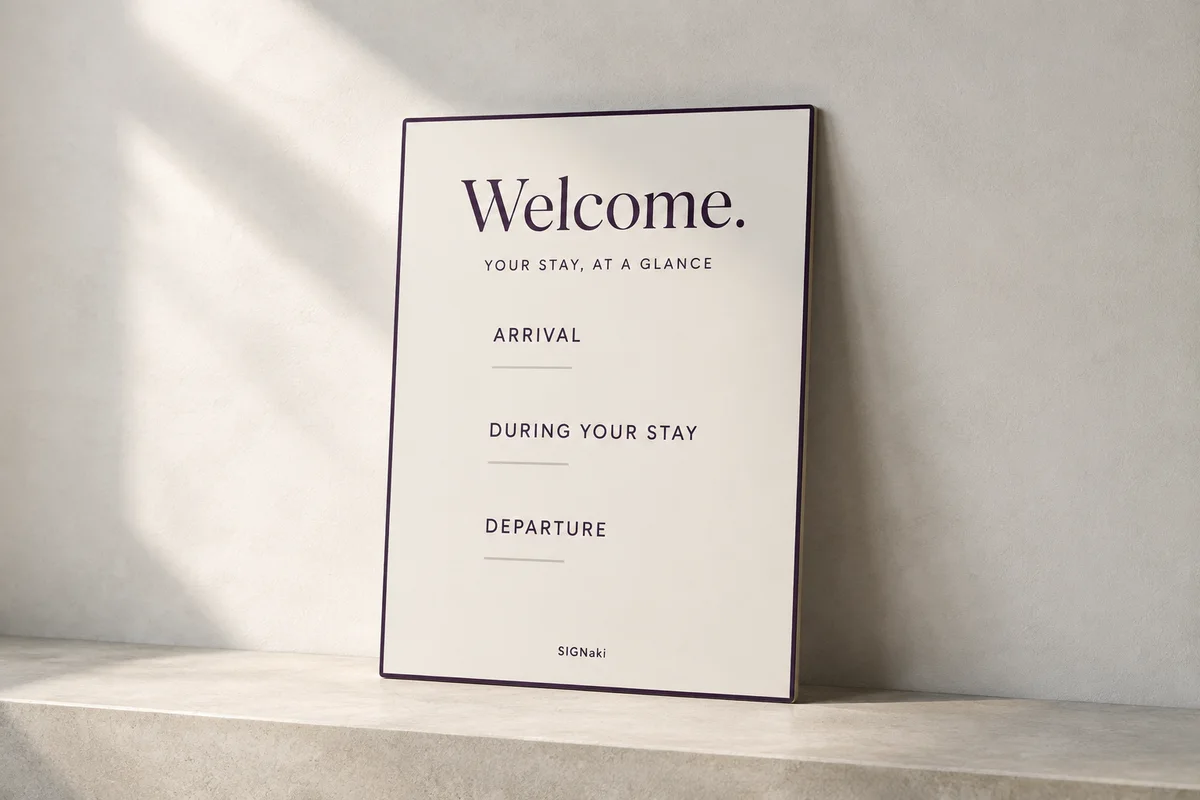 Illustrative design concept of a warm-white welcome board on a stone shelf, with purple headings for arrival, stay and departure